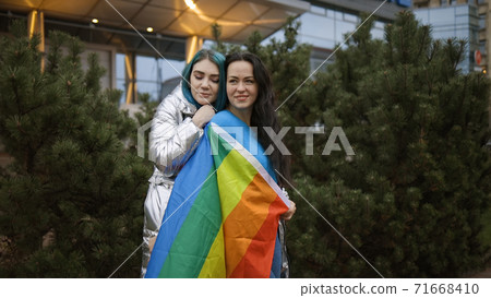 Two cute bisexual women hugging in public 71668410