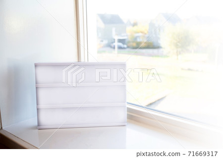 Blank empty Lightbox on window silk in a bright room with daylight, copy space or space for text. Modern design background Blank empty Lightbox on window silk in a bright room with daylight, copy space or space for text. Modern design background 71669317