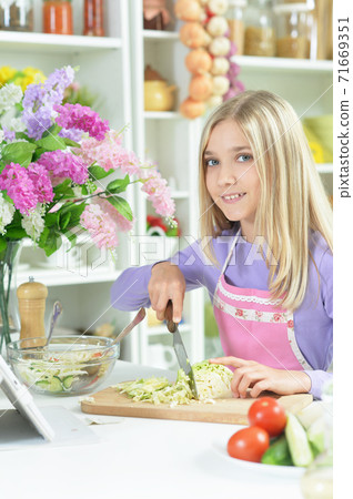 Portrait of cute girl preparing fresh salad 71669351