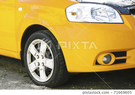 Wing, wheel and car headlight bright color, close-up Wing, wheel and car headlight bright color, close-up 71669605