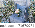 blue christmas tree and flowers on the armchair 71670074