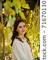 Warm autumn portrait of young pretty woman. 71670130