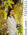 Warm autumn portrait of young pretty woman. 71670131