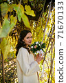 Warm autumn portrait of young pretty woman. 71670133