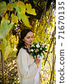 Warm autumn portrait of young pretty woman. 71670135