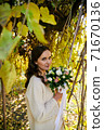 Warm autumn portrait of young pretty woman. 71670136