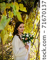 Warm autumn portrait of young pretty woman. 71670137