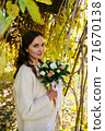 Warm autumn portrait of young pretty woman. 71670138