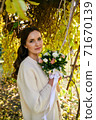 Warm autumn portrait of young pretty woman. 71670139