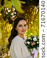 Warm autumn portrait of young pretty woman. 71670140