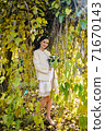 Warm autumn portrait of young pretty woman. 71670143