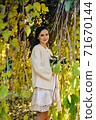 Warm autumn portrait of young pretty woman. 71670144