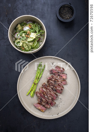 Traditional barbecue skirt steak sliced with green asparagus and salad  71670598