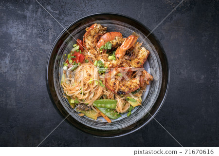 Traditional Thai phak kung curry with barbecue king prawns and noodles  71670616
