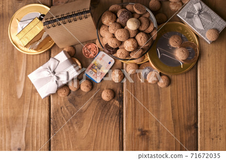 Dutch holiday postcard Sinterklaas. Wooden background with childrens shoe with carrots for Santa's 71672035