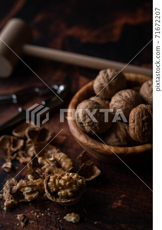 walnut with nutscracke on dark wooden backgrround walnut with nutscracke on dark wooden backgrround 71672207