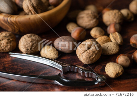 winter mix nuts image with hand cracker winter mix nuts image with hand cracker 71672216