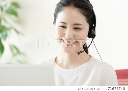 Young woman working in a call center Young woman working in a call center 71673740