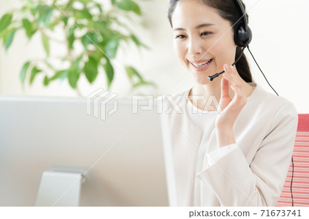 Young woman working in a call center Young woman working in a call center 71673741