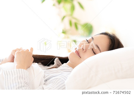 Young woman waking up in the bedroom 71674502