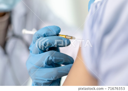 Doctor is vaccinating women with antibiotics or new antibodies to prevent the spread of the virus, Vaccination against communicable diseases concept 71676353