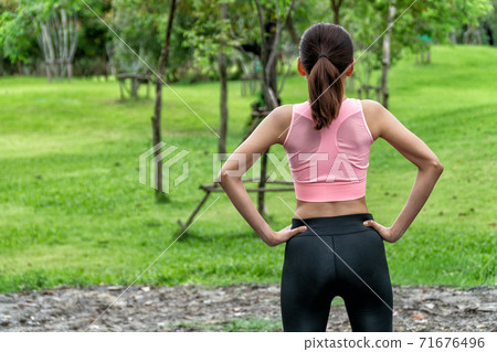Fitness and healthy lifestyle concept. The back of young woman wearing sport wear in the park. 71676496