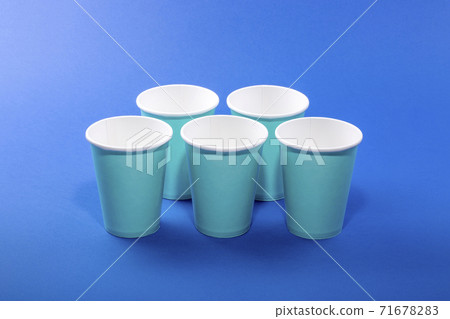 Eco disposable paper cups on blue background Eco disposable paper cups on blue background 71678283