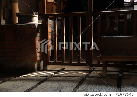 Okudo-san in the kitchen of the traditional dirt floor of the old house where the oblique light shines Okudo-san in the kitchen of the traditional dirt floor of the old house where the oblique light shines 71678546