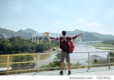 Man traveler with a backpack 71678922