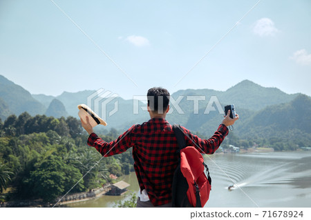 Man traveler with a backpack 71678924