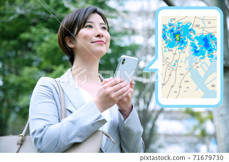 Image of a female office worker checking the rain cloud radar on a smartphone Image of a female office worker checking the rain cloud radar on a smartphone 71679730