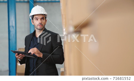Factory manager using tablet computer in warehouse or factory 71681552