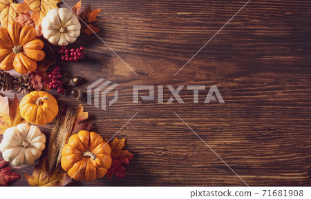 Thanksgiving background decoration from dry leaves and pumpkin on old wooden background. Flat lay, top view for Autumn, fall, Thanksgiving concept. 71681908