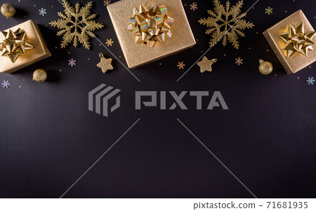 Top view of golden christmas boxes and snowflake on black background, Banner, poster composition. 71681935