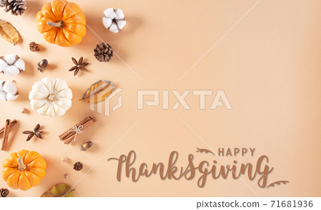 Thanksgiving background decoration from dry leaves and pumpkin on  pastel background. Flat lay, top view. 71681936