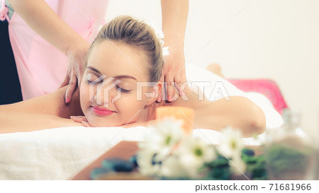 Woman gets back massage spa by massage therapist. Woman gets back massage spa by massage therapist. 71681966