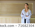 The female doctor was holding her arms smiling in the reception hall. 71682304