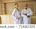 Two doctors were standing smiling in the reception hall. 71682305