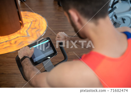 Close up picture of a man exercising in a gym machine 71682474