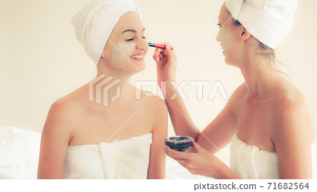 Beautiful woman having a facial treatment at spa. 71682564