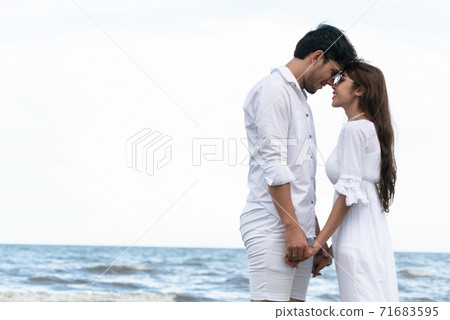 Couple going honeymoon on tropical beach in summer 71683595
