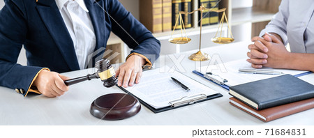 Female lawyer or Counselor working in courtroom have meeting with client are consultation with contract papers of real estate, Law and Legal services concept Female lawyer or Counselor working in courtroom have meeting with client are consultation with contract papers of real estate, Law and Legal services concept 71684831