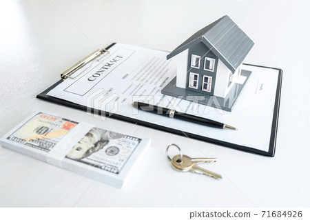 House model and Money, house key lying on real estate contract, home loan and investment concept 71684926