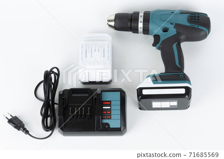 Cordless hammer screwdriver drill, battery charger and second battery on white background. Studio shoot. 71685569