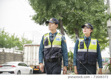Asian male and female two police officers 113 71686372
