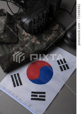Military symbols concep, South Korean flag and folded military uniform 08 Military symbols concep, South Korean flag and folded military uniform 08 71686982