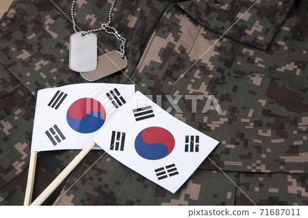 Military symbols concep, South Korean flag and folded military uniform 35 Military symbols concep, South Korean flag and folded military uniform 35 71687011