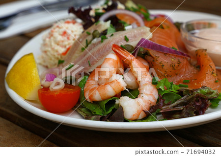 Cold and smoked seafood platter on wooden table Cold and smoked seafood platter on wooden table 71694032