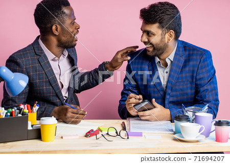 Two businessmen speaking and working at the office 71694207