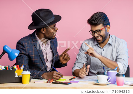 Two businessmen speaking and working at the office 71694215
